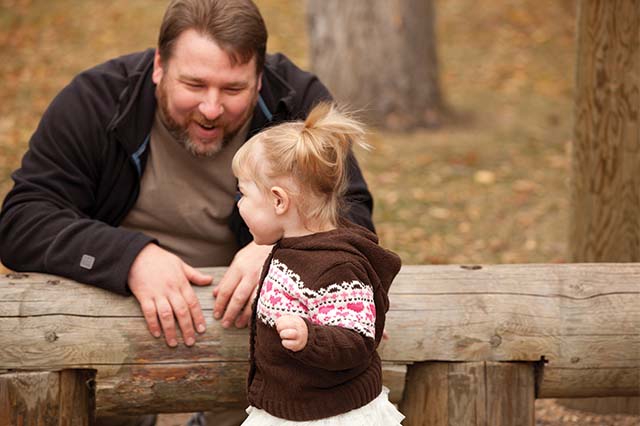 Parent and child playing outside.