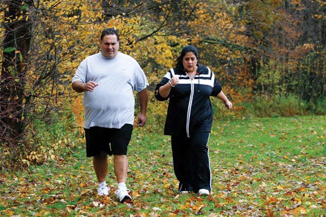 2 people walking briskly outside.